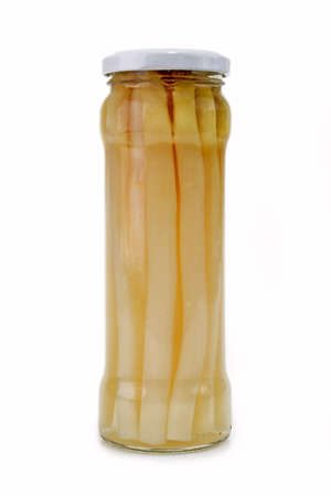 Container of white asparagus on bright backgroundの写真素材