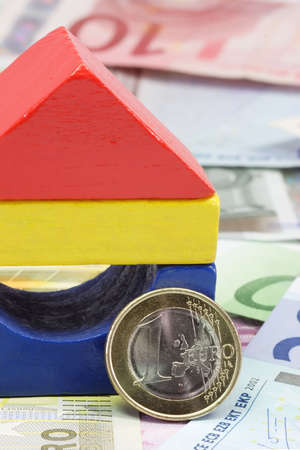 Colorful toy brick house with Euro banknotesの写真素材