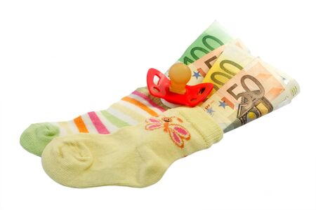  socks with pacifier and euro banknotes iIsolated on white background.の写真素材