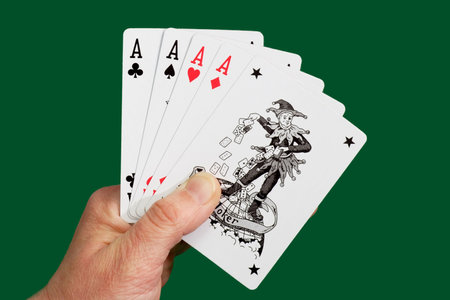 Playing cards on green background. Shot in studio.のeditorial素材