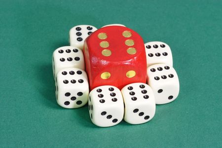White and red dice on green background