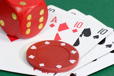 Red Dice with playing cards on green background