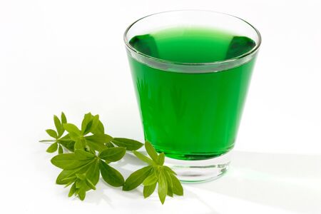 Close-up of a green woodruff drink with leavesの写真素材