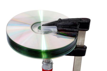 DVD disk in a screw clamp isolated on white backgroundの写真素材