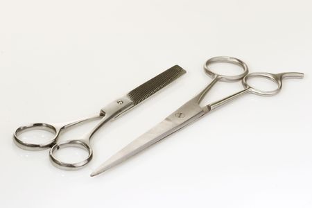 Haircutting scissors on bright background