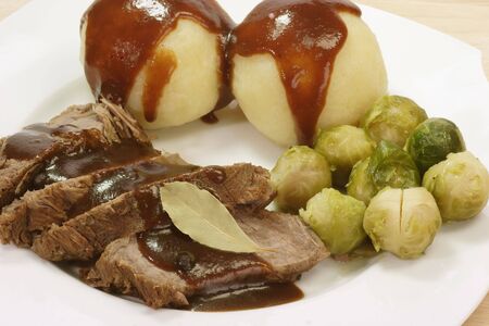 Roasted beef with potatoe dumbling and brussel sproutsの写真素材