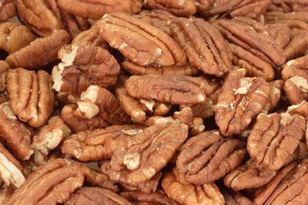 Pecan nuts in detail as background.