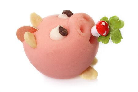 Lucky marzipan pig with cloverleaf and mushroom, on bright backgroundの写真素材