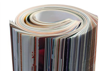 Rolled up magazine on bright backgroundの写真素材