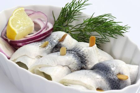 Rolled herring in a bowl on bright backgroundの写真素材