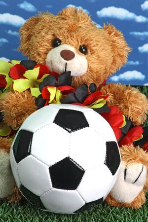 Cute teddy bear with a soccerball onb right backgroundの写真素材
