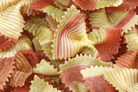 Red and yellow noodles close up as backgroundの写真素材