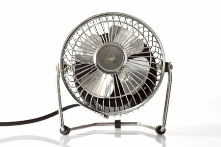 Electric silver fan  on bright backgroundの写真素材
