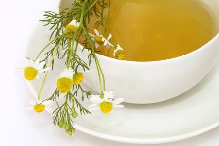 Herbal camomile tea on bright backgroundの写真素材