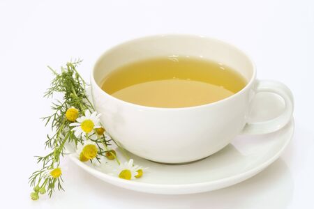 Herbal camomile tea on bright backgroundの写真素材