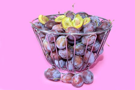 Fresh plums in a bowl. Shot in studio.の写真素材