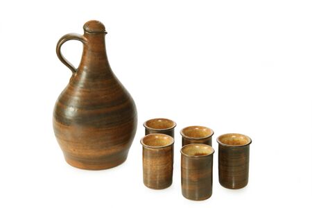 Liqueur bottle with mugs isolated on white backgroundの写真素材