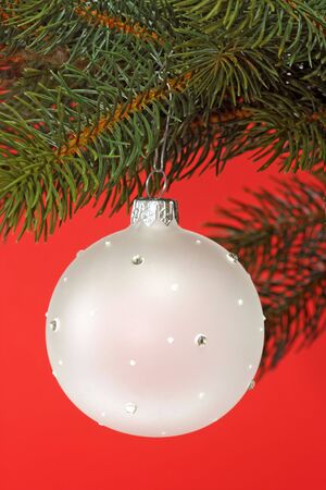 Decorative chrismas ball on red backgroundの写真素材