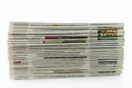 German newspaper stack on white backgroundの写真素材