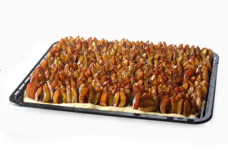 Fresh plums on a plum cake on bright backgroundの写真素材