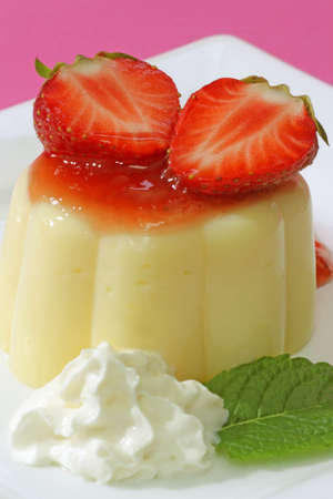 Delicious vanilla custard with fresh strawberries in detail-.の写真素材