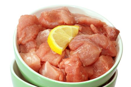Fresh raw pieces of pork meat on bright backgroundの写真素材