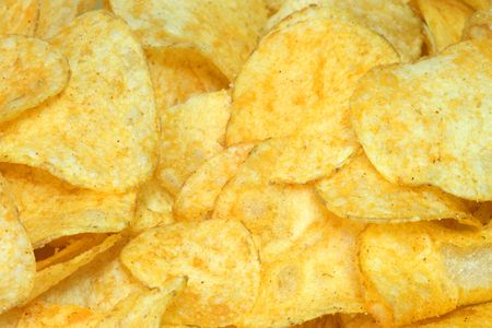 Crispy potato chips as background. Shot in studio.の写真素材