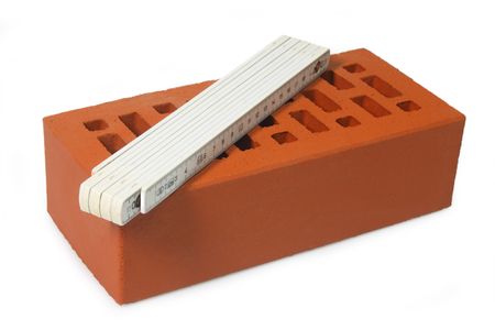 Red brick and folding rule isolated on white backgroundの写真素材