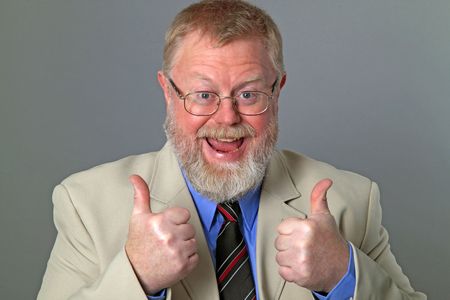 Thumbs up business man on grey backgroundの写真素材