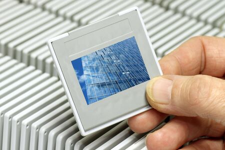 Hand holding a plastic picture slide frame. の写真素材