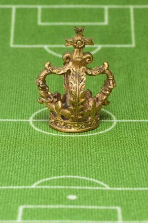 Symbol photo - crown on a soccer field. Shot in studio.の写真素材