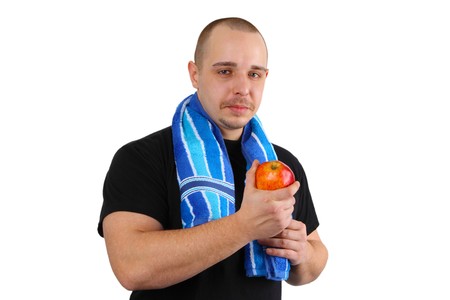Young sportsman  man holds red  apple on white backgroundの写真素材