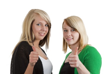 Two young caucasian girlfriends having fun together  isolated over white backgroundの写真素材