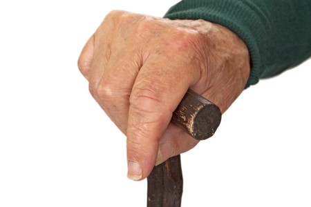 Hands of old man with walking stick - detail shot.

の写真素材