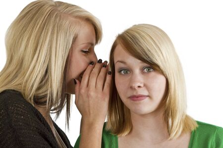 Blond  haired girls gossip isolated over white backgroundの写真素材