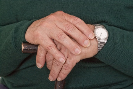 Hands of old man with walking stick - detail shot.

の写真素材