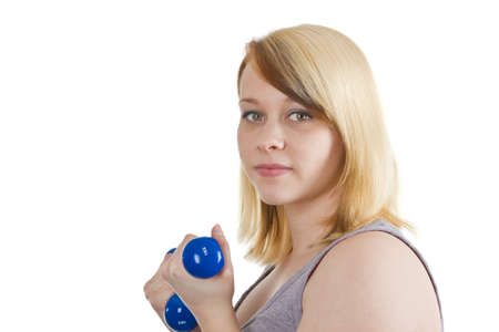 Young woman with dumbbell - isolated on white
の写真素材