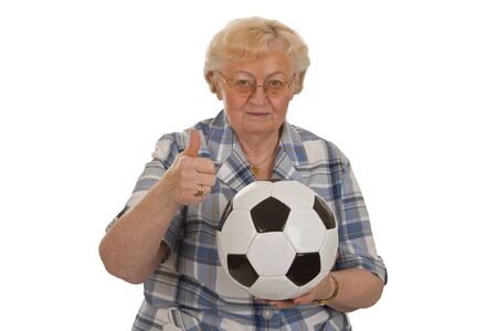 Female senior with soccer ball - isolated on white backgroundの写真素材