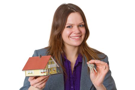 Female real estate agent with keys and modell house over white background

の写真素材