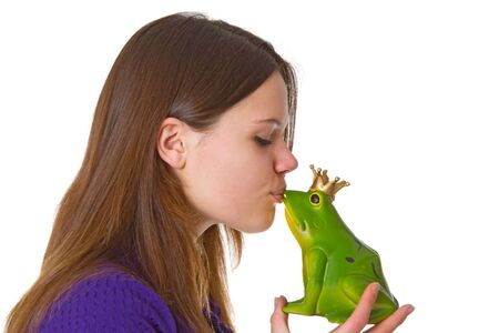 Young beautiful woman with a toy frog prince on white background.の写真素材