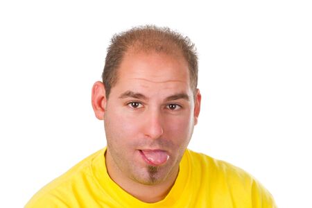 Young man with put out a tongue isolated on white backgroundの写真素材