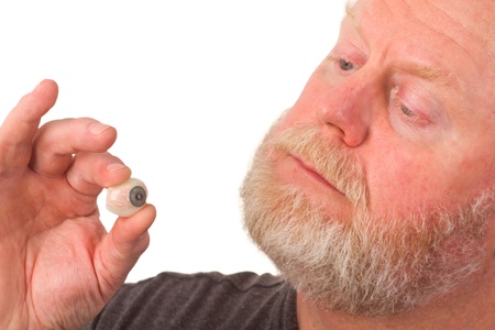 Eye specialist holding glass eye - isolated on white backgroundの写真素材