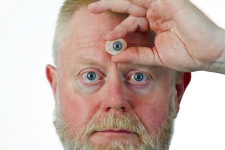 Man hold glasseye on his forehead