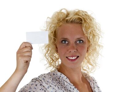 Smiling woman holding up a blank business card - isolated on white backgroundの写真素材