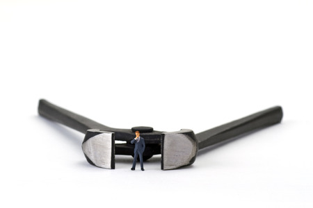 Figurine with pincers on bright backgroundの写真素材