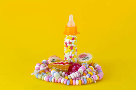 Colorful Candy on yellow backgroundの写真素材