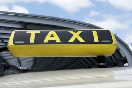Taxi sign against blue sky in Summerの写真素材