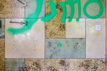 Old ceramic wall tile with green painting in detail as background