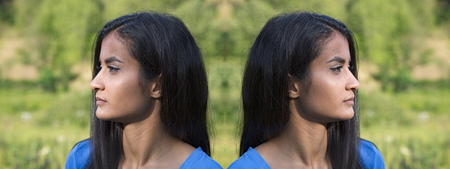 Beautiful offended young twins, outdoor shooting in summerの写真素材