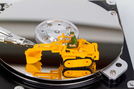 HDD with toy crawler mounted - data security concept.の写真素材